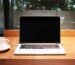 laptop computer beside coffee mug